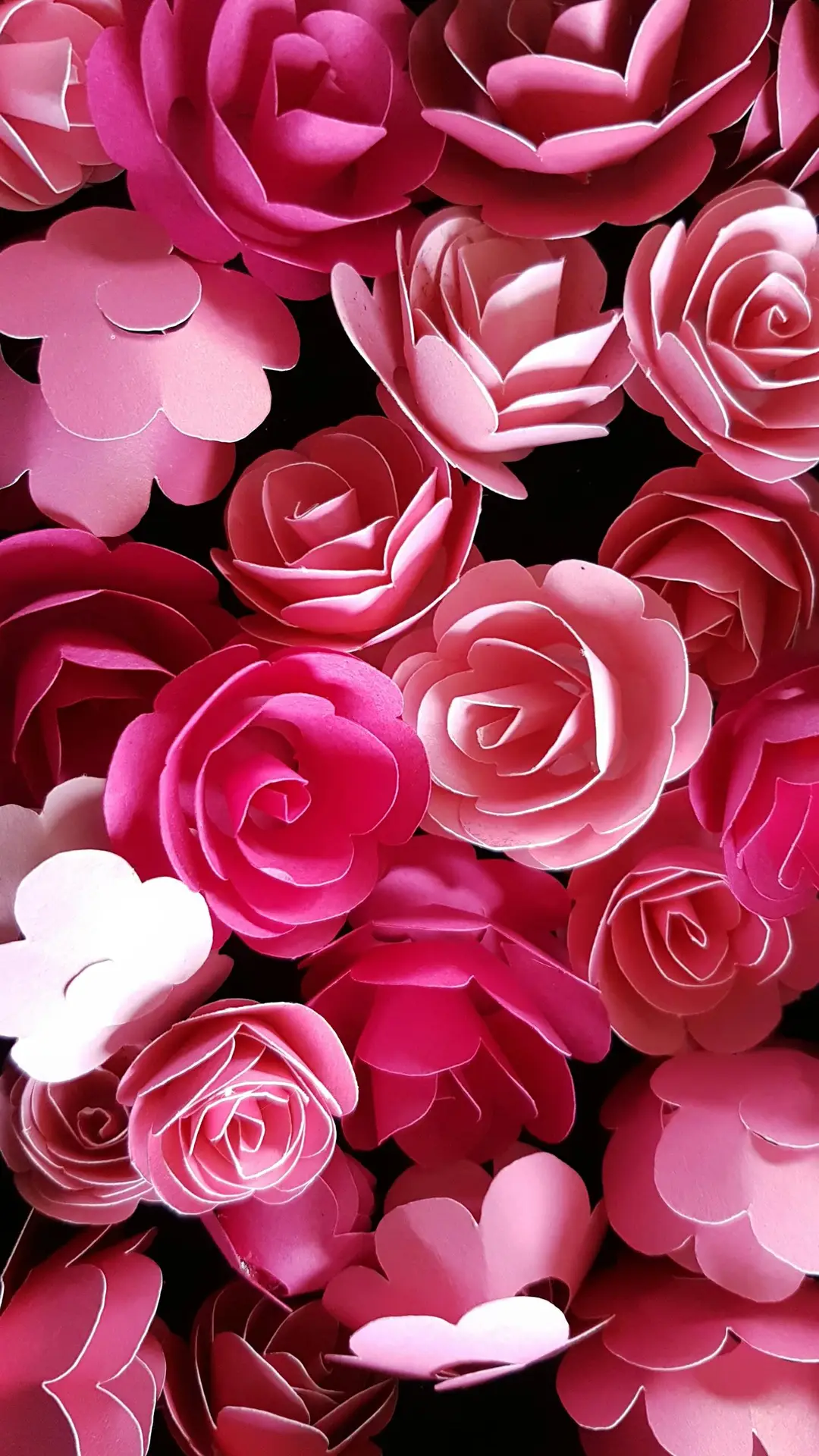 A striking arrangement of pink paper roses, perfect for floral-themed designs and backgrounds.